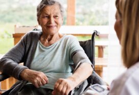 Image shows woman in wheelchair having her blood pressure checked
