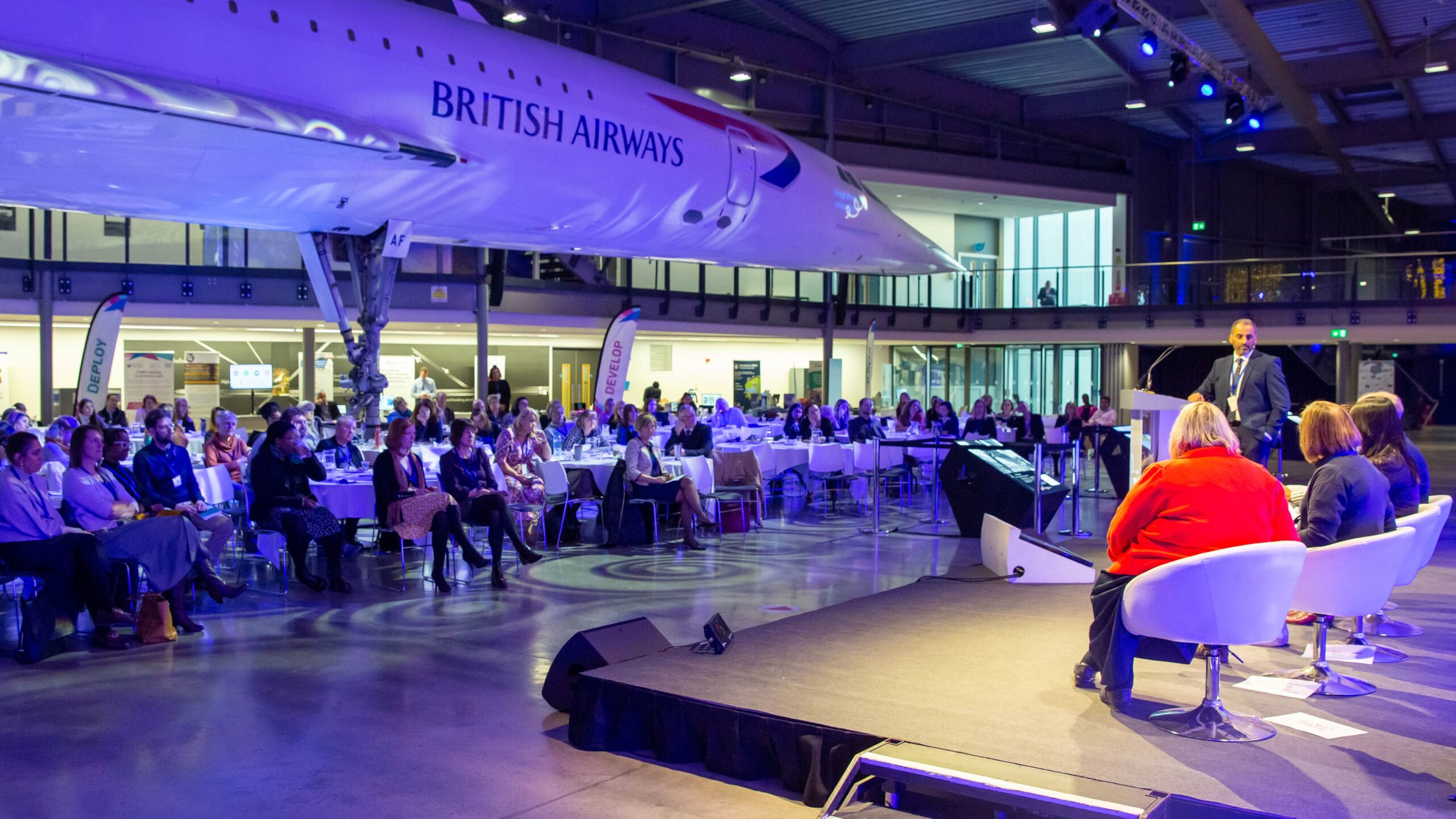 Photo shows panel session at the Integrating Innovation conference at Aerospace Bristol with Concorde in the background