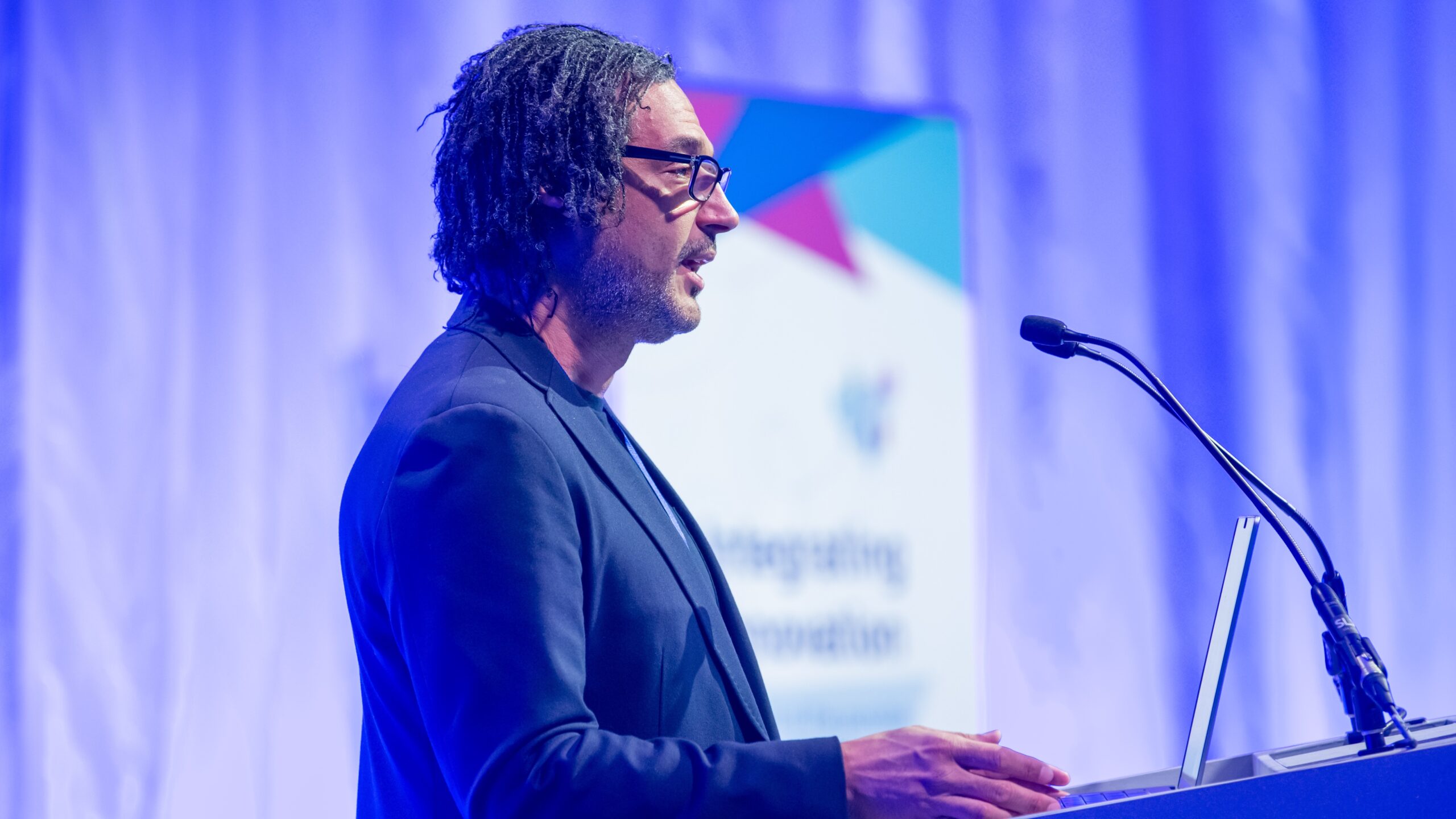 Photo shows David Olusoga speaking at the Integrating Innovation conference
