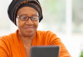 Photo shows a woman using a tablet