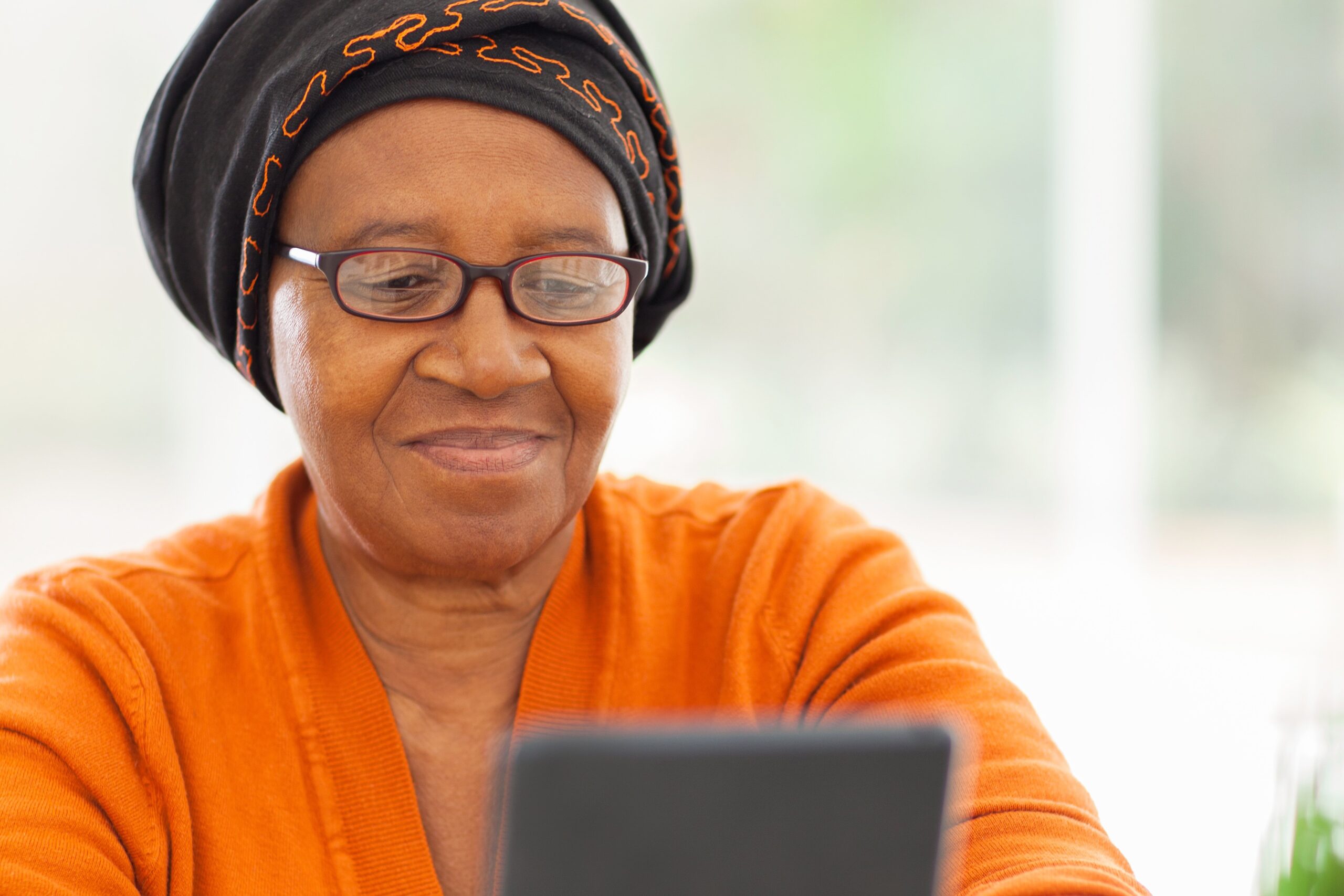 Photo shows a woman using a tablet