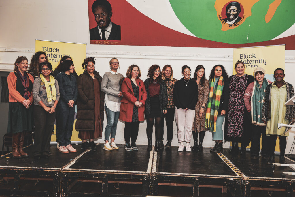 Group of Black Maternity Matters participants gathered on stage
