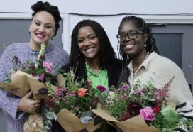 Katie, Sonah and Karen smiling with bouquets of flowers
