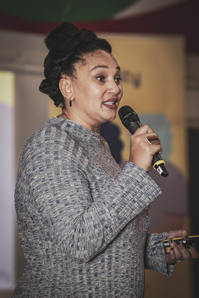 Katie Donovan-Adekanmbi speaking into a microphone