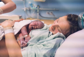 White mother and newborn. Child birth in maternity hospital.