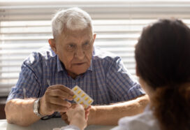 Senior Caucasian male patient consult with doctor about medication pills prescription. Old mature man client get medicines from GP at consultation in hospital. Healthcare, elderly medicine concept.