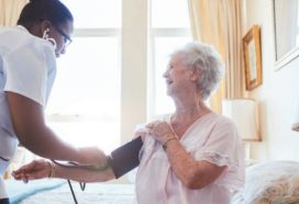 Care home resident having blood pressure checked