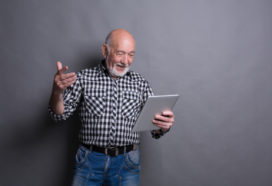 Man reading news on digital tablet