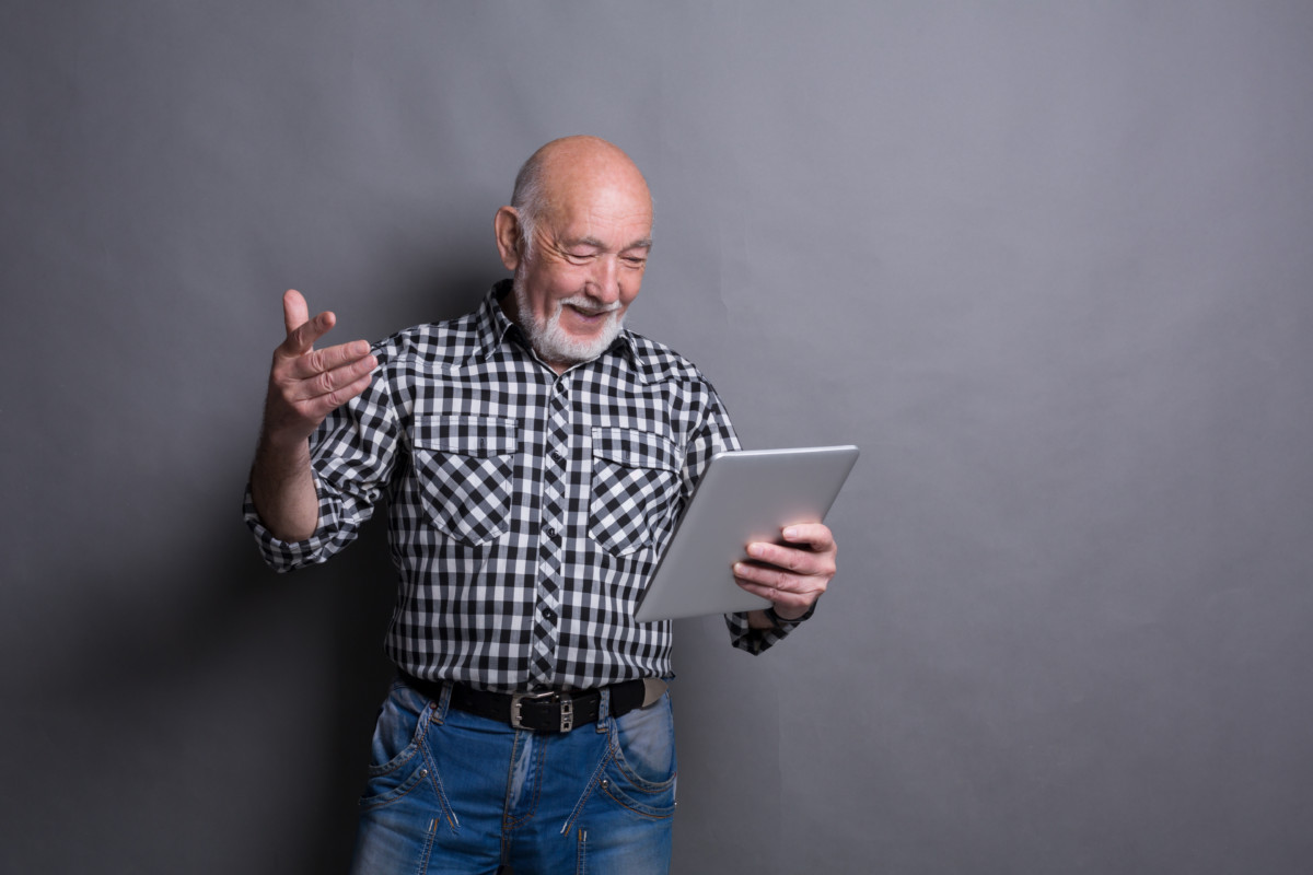 Man reading news on digital tablet