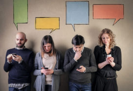 People having a conversation via mobile phones